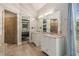 The bathroom features a double sink vanity with granite countertops, tiled floors, and views to the main bedroom at 1210 Swan Mill Ct, Suwanee, GA 30024