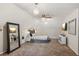 This spacious bedroom features a cozy sitting area, large mirror, and unique light fixtures at 1210 Swan Mill Ct, Suwanee, GA 30024