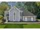 Side view of home, highlighting architectural details, well maintained landscaping, and curb appeal at 1210 Swan Mill Ct, Suwanee, GA 30024