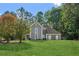 Charming gray two-story home with a manicured lawn and mature trees offering curb appeal at 1210 Swan Mill Ct, Suwanee, GA 30024