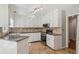 Spacious kitchen featuring granite countertops, tiled floors, and ample cabinet space at 1210 Swan Mill Ct, Suwanee, GA 30024