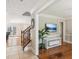 Foyer with tiled floors, an ornate staircase, and a spacious living room with hardwood floors at 1210 Swan Mill Ct, Suwanee, GA 30024