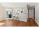 Open-concept living room with hardwood floors and a view to the kitchen breakfast bar at 1210 Swan Mill Ct, Suwanee, GA 30024