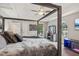 Large main bedroom featuring a vaulted ceiling, a ceiling fan and views of the backyard at 1210 Swan Mill Ct, Suwanee, GA 30024