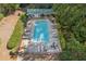 Aerial view of a rectangular community pool with ample chairs and lounge areas for residents at 1210 Swan Mill Ct, Suwanee, GA 30024
