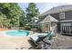 A backyard pool with lounge chairs provides relaxation and recreation at this beautiful home at 1210 Swan Mill Ct, Suwanee, GA 30024