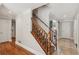Foyer with wooden staircase, complemented by hardwood and tile flooring at 1210 Swan Mill Ct, Suwanee, GA 30024