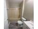 This bathroom has gray wood-look flooring, vanity with sink, toilet and tub with shower at 32 Sherwood Loop, Mcdonough, GA 30253