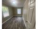 Empty bedroom with wood-look flooring, freshly painted walls, and natural light at 32 Sherwood Loop, Mcdonough, GA 30253