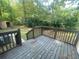 The deck has brown wood and a wooded view of the backyard at 32 Sherwood Loop, Mcdonough, GA 30253