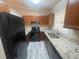 Kitchen featuring granite counters, updated appliances, and painted wood cabinets at 32 Sherwood Loop, Mcdonough, GA 30253