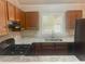 Kitchen featuring granite counters, updated appliances, and painted wood cabinets at 32 Sherwood Loop, Mcdonough, GA 30253