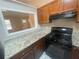 Kitchen featuring granite counters, updated appliances, and painted wood cabinets at 32 Sherwood Loop, Mcdonough, GA 30253