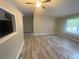 This living room features a ceiling fan and gray wood-look flooring at 32 Sherwood Loop, Mcdonough, GA 30253