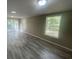 The living room features gray wood-look flooring and access to the outside from glass doors at 32 Sherwood Loop, Mcdonough, GA 30253