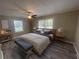 Bedroom showcasing a queen bed, wood-look flooring, and natural light at 32 Sherwood Loop, Mcdonough, GA 30253