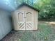 This backyard shed has double doors and is next to the house at 32 Sherwood Loop, Mcdonough, GA 30253