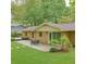 Lush backyard featuring a patio, well-manicured lawn, and mature trees providing shade at 246 Plantation Sw Rd, Smyrna, GA 30082