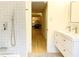 Contemporary bathroom with a double vanity, modern fixtures, and a view into the hallway at 246 Plantation Sw Rd, Smyrna, GA 30082