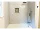 Modern bathroom featuring a tub with sleek white subway tile and rainfall shower head at 246 Plantation Sw Rd, Smyrna, GA 30082