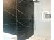 Modern bathroom featuring sleek black marble, stand up shower, and white vanity at 246 Plantation Sw Rd, Smyrna, GA 30082