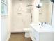 Modern bathroom featuring a walk-in shower with marble-style tiling and sleek fixtures at 246 Plantation Sw Rd, Smyrna, GA 30082