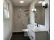 Bathroom featuring a sleek vanity, dual lighting fixtures, and walk-in shower with modern design at 246 Plantation Sw Rd, Smyrna, GA 30082