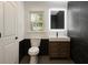 Stylish bathroom with marble accent wall, modern vanity, and backlit mirror providing excellent lighting at 246 Plantation Sw Rd, Smyrna, GA 30082