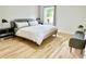 Cozy bedroom with hardwood floors, black bedside tables, and a grey accent bench at 246 Plantation Sw Rd, Smyrna, GA 30082