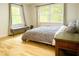 Light-filled bedroom with hardwood floors, large windows, and a stylish gray color scheme at 246 Plantation Sw Rd, Smyrna, GA 30082