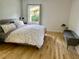 Bedroom featuring a comfortable bed, natural light from a window, and hardwood floors at 246 Plantation Sw Rd, Smyrna, GA 30082