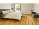Cozy bedroom featuring hardwood floors, a comfortable bed, and a window providing natural light at 246 Plantation Sw Rd, Smyrna, GA 30082