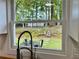 Kitchen window view of outdoor seating, backyard with shed, and rock terracing at 246 Plantation Sw Rd, Smyrna, GA 30082