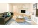 Cozy living room with light wood floors, a fireplace, a black leather sofa and stylish decor at 246 Plantation Sw Rd, Smyrna, GA 30082