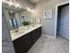 Elegant bathroom featuring a double vanity with marble floors and plenty of cabinet space at 3587 Fishpond Cir, Dacula, GA 30019