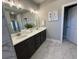 Bright bathroom featuring a double vanity with marble floors and modern fixtures at 3587 Fishpond Cir, Dacula, GA 30019