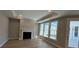 Cozy living room with a fireplace and large windows for natural light at 3587 Fishpond Cir, Dacula, GA 30019