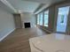 Bright living room with fireplace and hardwood floors, open to outdoor patio at 3587 Fishpond Cir, Dacula, GA 30019