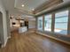 Bright living area featuring large windows, an open floor plan, and wood-look flooring at 3587 Fishpond Cir, Dacula, GA 30019