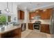Modern kitchen featuring stainless steel appliances, granite countertops, and dark wood cabinets at 3621 Vinings Slope Se # 3411, Atlanta, GA 30339