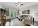 Bright living room with ceiling fan, hardwood floors, comfortable seating, and balcony access at 3621 Vinings Slope Se # 3411, Atlanta, GA 30339