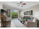 Bright living room with ceiling fan, hardwood floors, comfortable seating, and balcony access at 3621 Vinings Slope Se # 3411, Atlanta, GA 30339