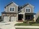 Charming two-story home with a two-car garage, stone accents, and well-manicured landscaping at 328 Willow Cv, Canton, GA 30114
