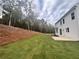 Side view of backyard with a grassy area and view of the house at 337 Willow Cv, Canton, GA 30114