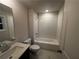 Stylish bathroom with white subway tile, shower-tub combo, vanity, and tile floors at 337 Willow Cv, Canton, GA 30114
