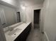 Bathroom featuring dual sinks, modern fixtures, and tile flooring at 337 Willow Cv, Canton, GA 30114