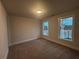Carpeted bedroom with two windows and neutral wall color offers a serene space at 337 Willow Cv, Canton, GA 30114