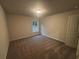 Neutral-toned bedroom with carpet and a window at 337 Willow Cv, Canton, GA 30114