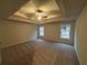 Primary bedroom with a tray ceiling and large windows at 337 Willow Cv, Canton, GA 30114