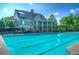 Inviting community pool and clubhouse with stone accents, a covered veranda and lounge chairs for relaxing at 337 Willow Cv, Canton, GA 30114